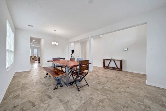 dining area featuring a notable chandelier