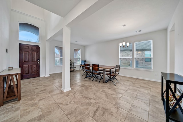 foyer featuring a notable chandelier and a healthy amount of sunlight