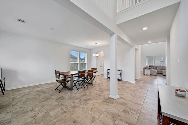 dining area with an inviting chandelier