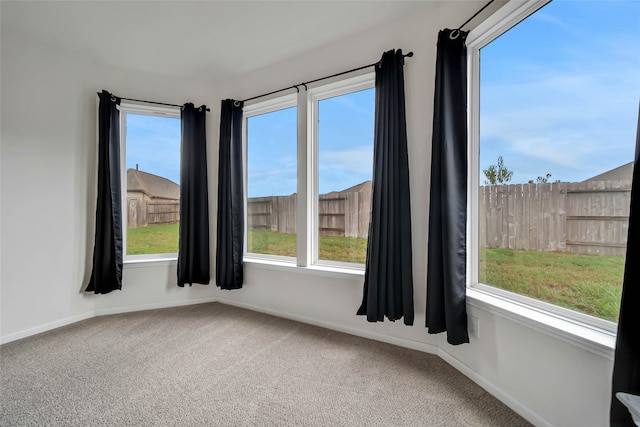 carpeted empty room featuring a healthy amount of sunlight