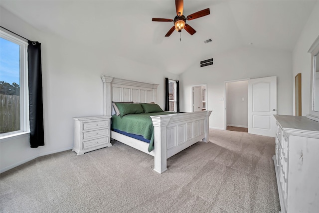 unfurnished bedroom featuring ceiling fan, light carpet, and vaulted ceiling