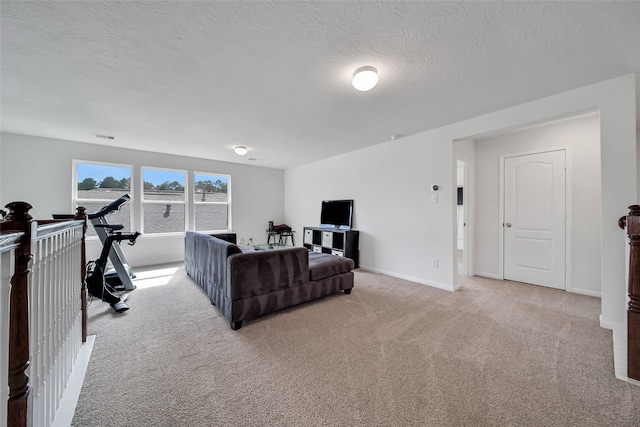 carpeted living room with a textured ceiling