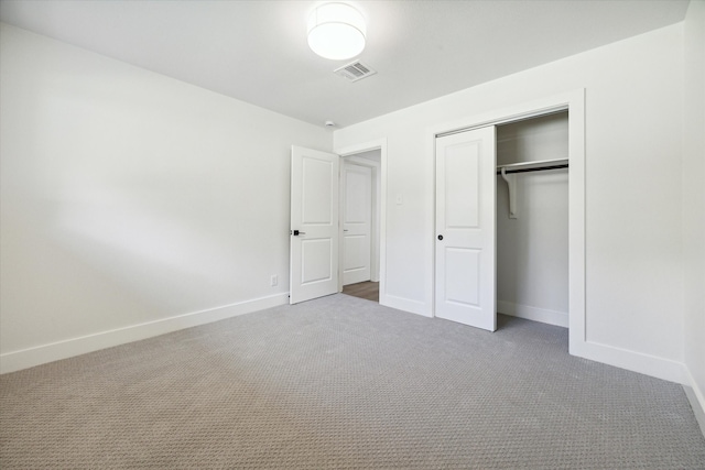 unfurnished bedroom featuring carpet floors and a closet