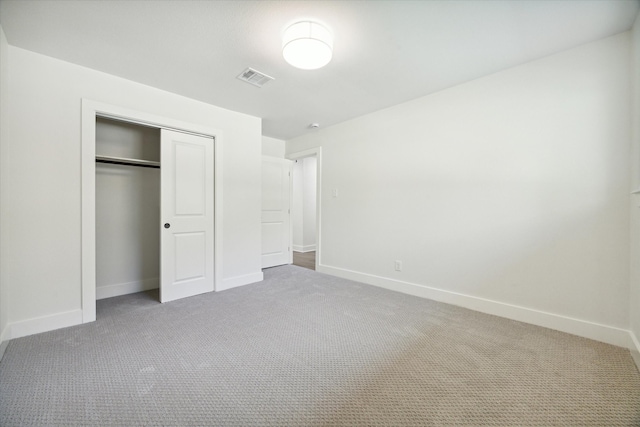 unfurnished bedroom with carpet floors and a closet