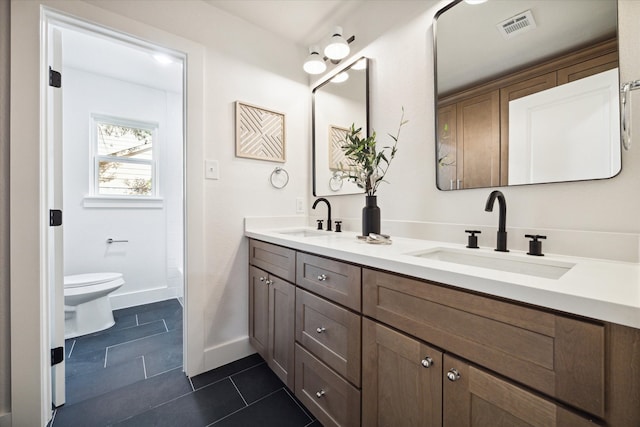 bathroom featuring tile patterned flooring, vanity, and toilet