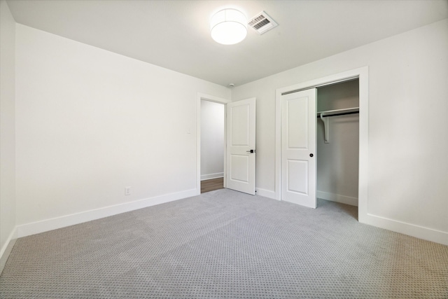 unfurnished bedroom with carpet floors and a closet