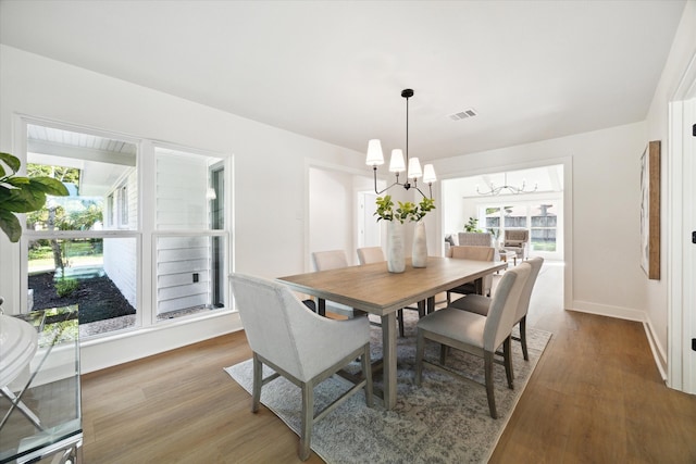 dining room featuring an inviting chandelier and hardwood / wood-style flooring