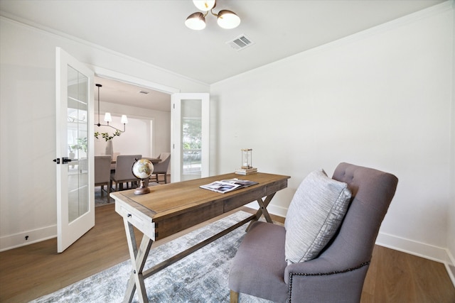 home office with ornamental molding, french doors, dark wood-type flooring, and a notable chandelier