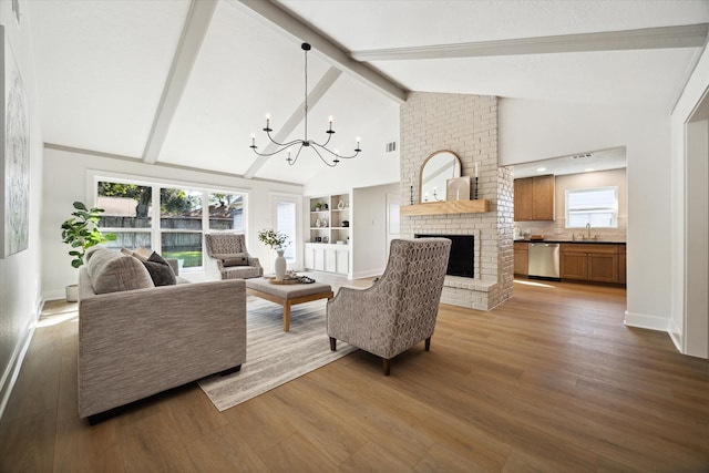 living room featuring sink, dark wood-type flooring, lofted ceiling with beams, and a notable chandelier