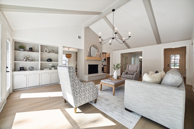 living room featuring high vaulted ceiling, an inviting chandelier, a brick fireplace, light wood-type flooring, and beamed ceiling