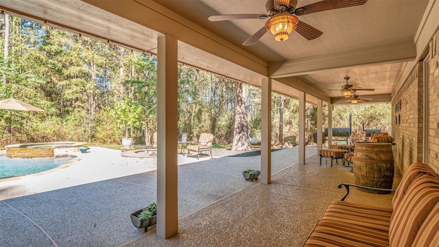 view of patio featuring ceiling fan and a swimming pool with hot tub