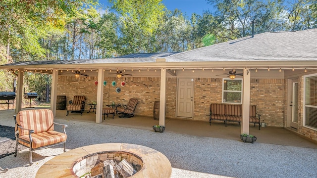 view of patio / terrace featuring a fire pit and ceiling fan