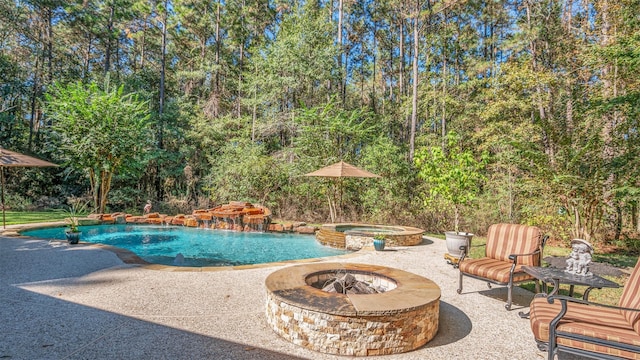 view of pool with a patio area, an in ground hot tub, and a fire pit