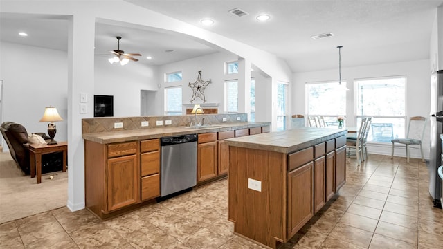 kitchen featuring dishwasher, a kitchen island, plenty of natural light, and hanging light fixtures