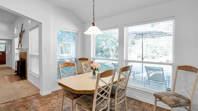 dining room with carpet flooring and lofted ceiling