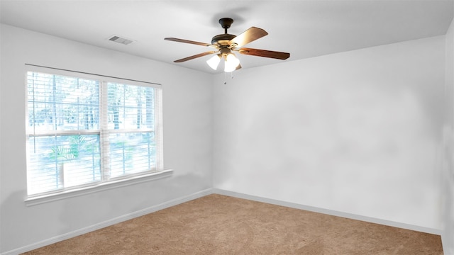 unfurnished room featuring light carpet and ceiling fan