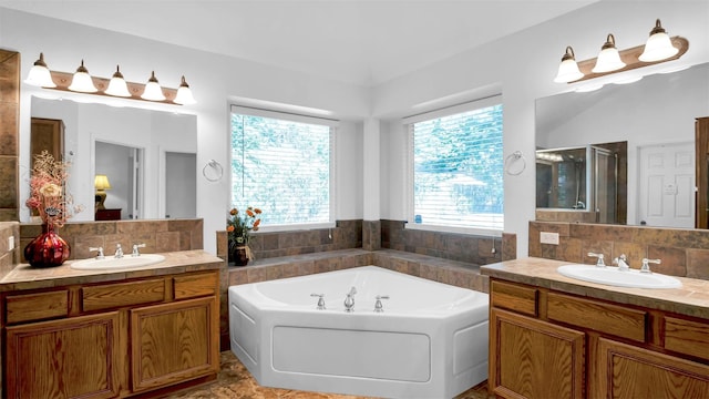 bathroom with plus walk in shower, vanity, and backsplash