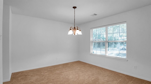 unfurnished room featuring light colored carpet and an inviting chandelier