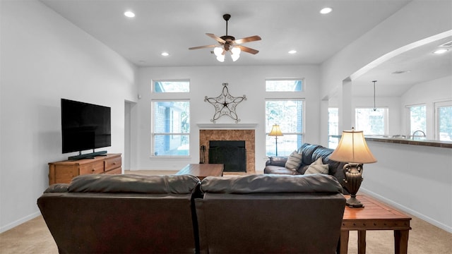 carpeted living room featuring ceiling fan