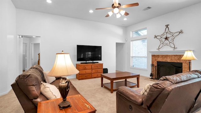 carpeted living room with ceiling fan and a towering ceiling