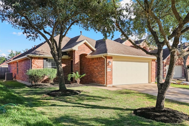 ranch-style home featuring a garage and a front lawn