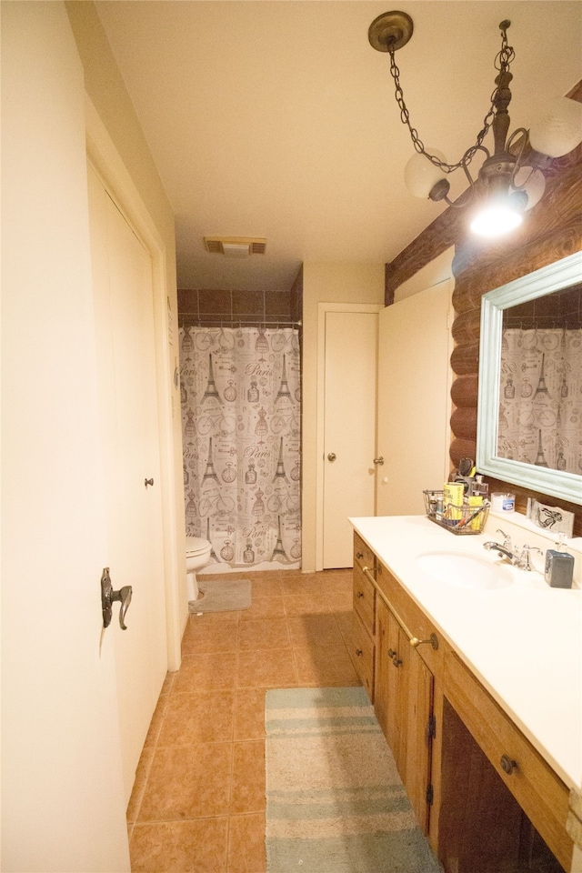 bathroom with tile patterned flooring, vanity, and toilet