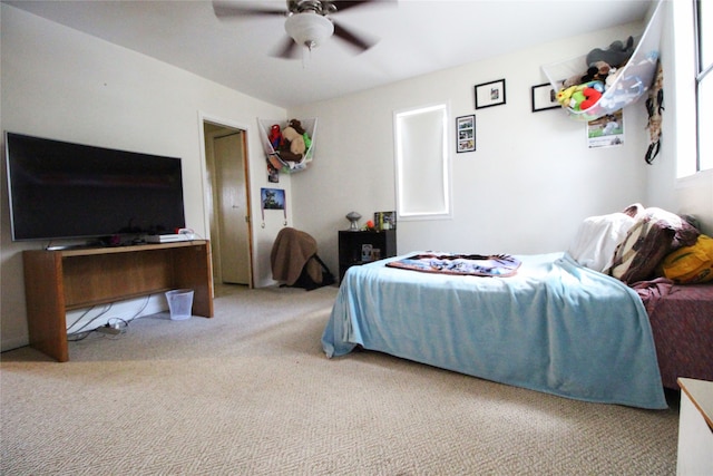 bedroom with ceiling fan and light carpet