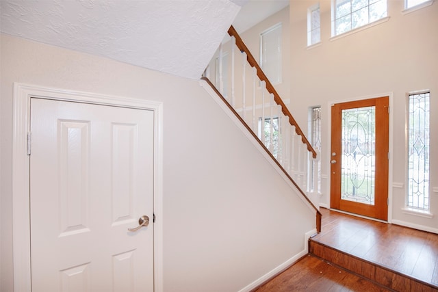 foyer with plenty of natural light and hardwood / wood-style floors