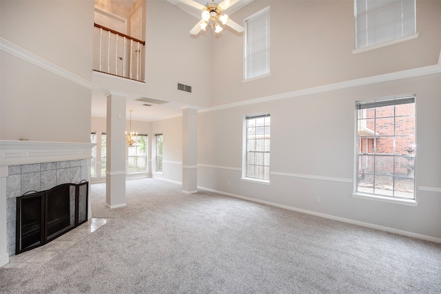 unfurnished living room with plenty of natural light, light colored carpet, and a high ceiling