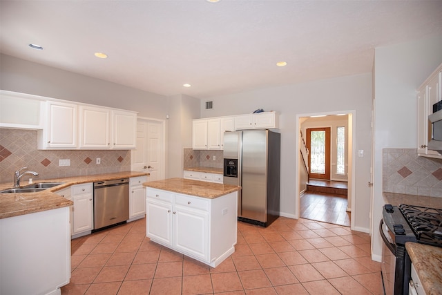 kitchen with a center island, white cabinetry, sink, and appliances with stainless steel finishes