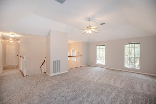 unfurnished living room with ceiling fan, lofted ceiling, and light carpet