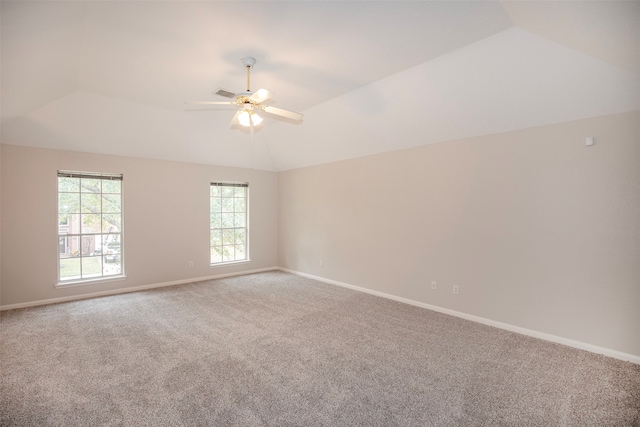 empty room with carpet, ceiling fan, and vaulted ceiling