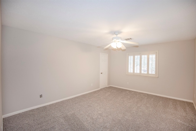 carpeted spare room with ceiling fan