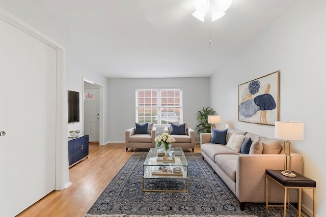 living room featuring ceiling fan and light hardwood / wood-style flooring