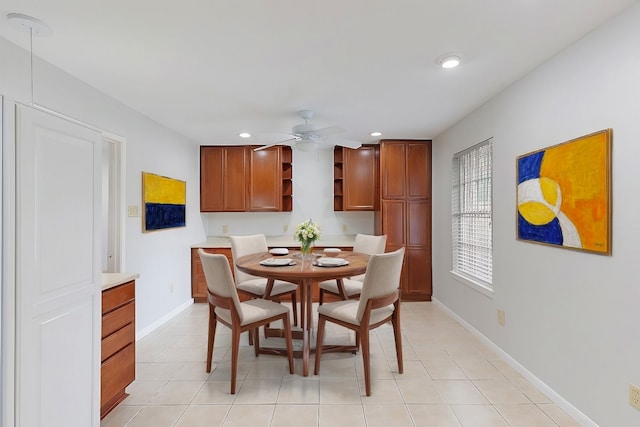 dining space with light tile patterned floors and ceiling fan