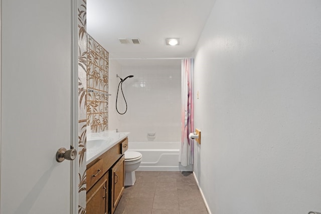 full bathroom featuring toilet, vanity, tile patterned floors, and tiled shower / bath