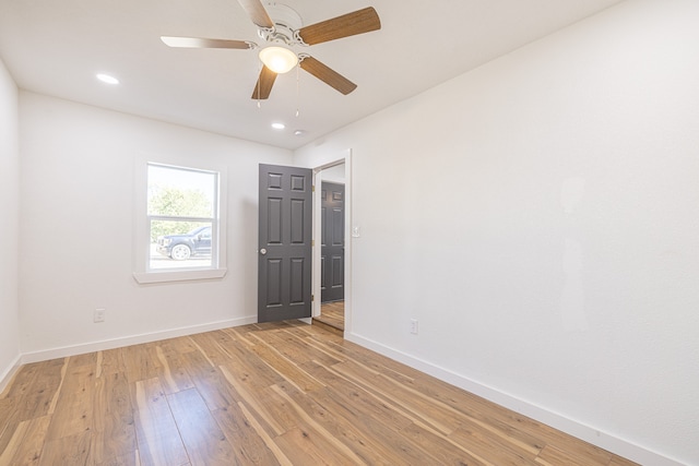 spare room featuring ceiling fan and light wood-type flooring