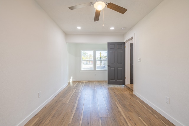 unfurnished room featuring light hardwood / wood-style floors and ceiling fan