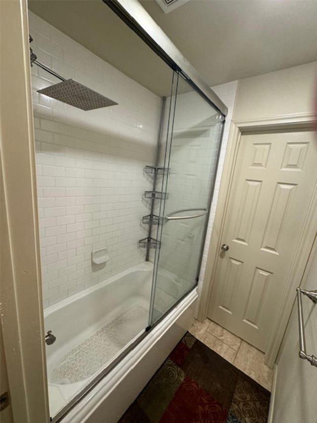 bathroom featuring combined bath / shower with glass door