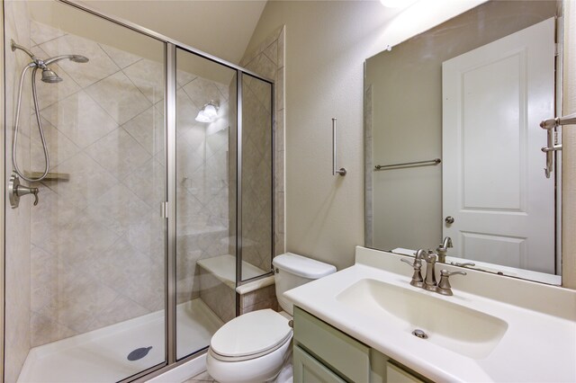 bathroom featuring toilet, vanity, lofted ceiling, and walk in shower