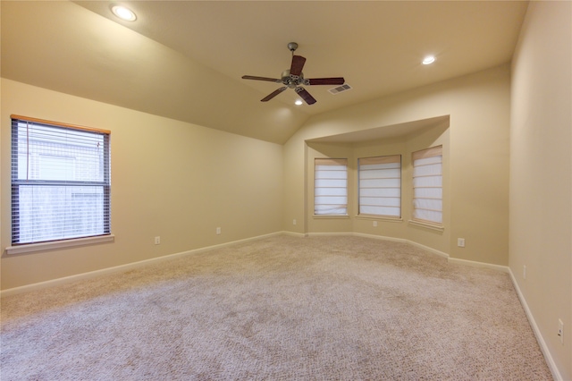 carpeted empty room featuring ceiling fan and vaulted ceiling