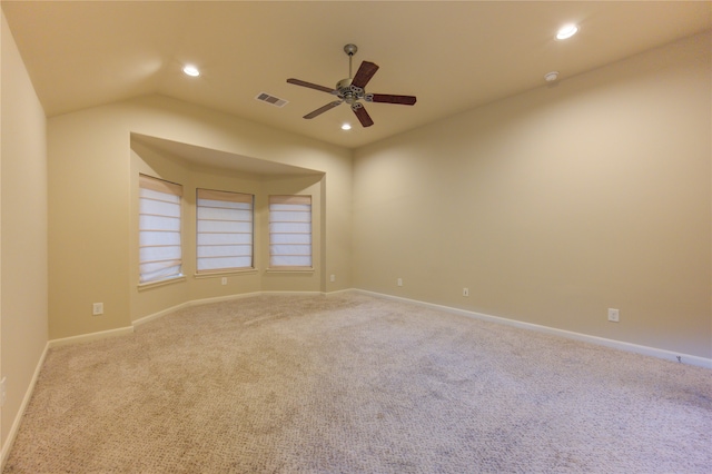 carpeted empty room featuring vaulted ceiling and ceiling fan