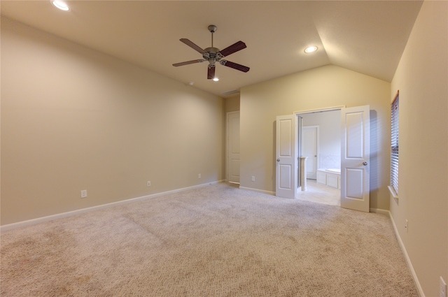 carpeted spare room with ceiling fan and lofted ceiling