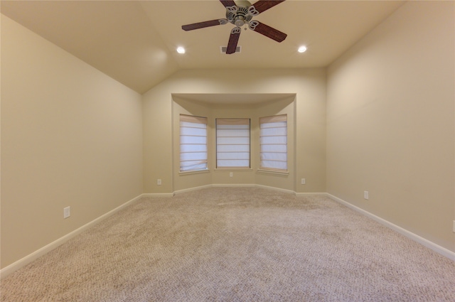 unfurnished room with light carpet, ceiling fan, and vaulted ceiling