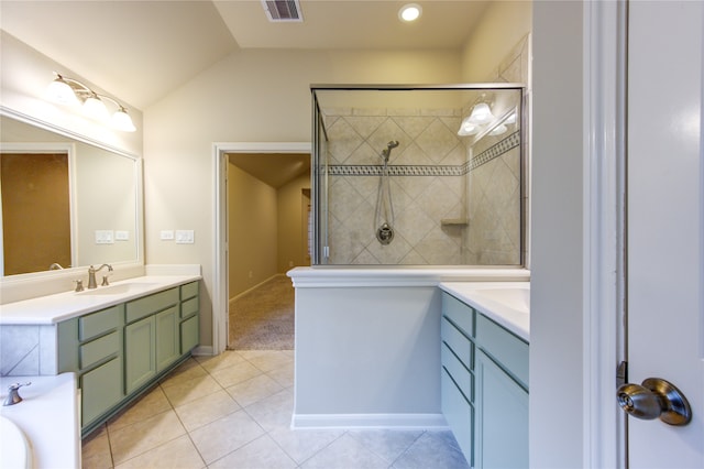 bathroom with tile patterned flooring, vanity, lofted ceiling, and tiled shower