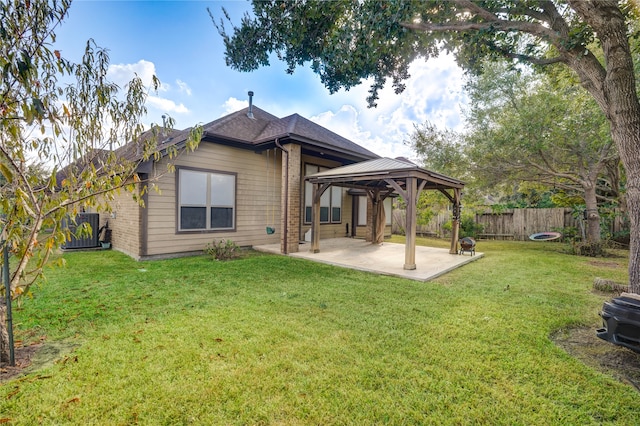 back of house with a gazebo, a yard, and a patio