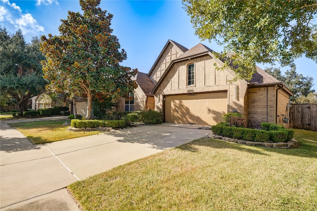 view of front of home featuring a garage and a front lawn