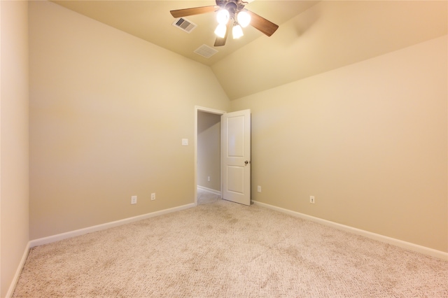 empty room with light colored carpet, ceiling fan, and lofted ceiling