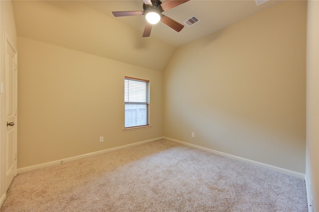 carpeted spare room with ceiling fan and lofted ceiling