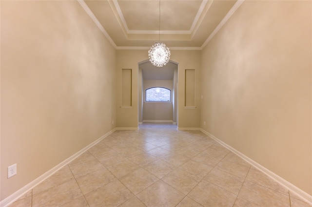 interior space with a raised ceiling, ornamental molding, light tile patterned floors, and a chandelier